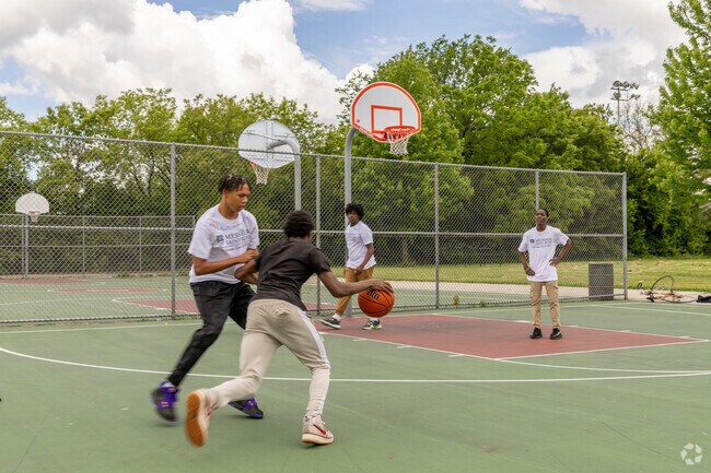 Merrill Park residents play a game of basketball at the neighborhood park.