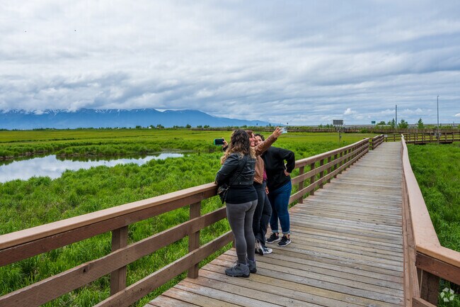 Friends enjoy the views at Potter Marsh Wildlife Viewing Boardwalk near Old Seward-Oceanview.