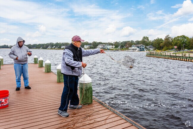 Men fishing for crabs and casting the cages into the water Pine Beach, NJ.