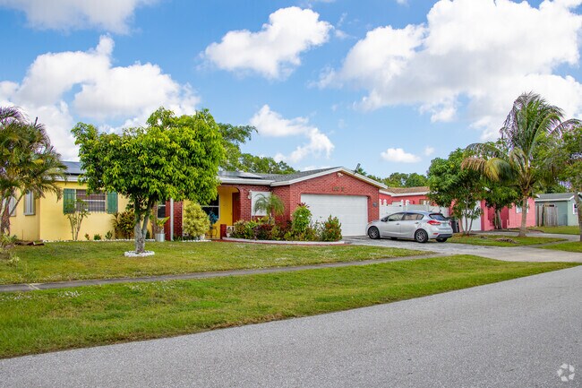Colorful single family homes lining up on the streets of Palm Beach Lakes South.