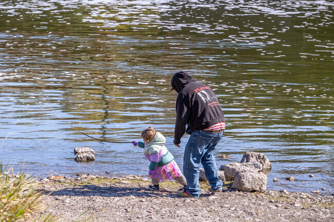 Parents of Algonquin Heights catch the fresh air outdoors with their children.