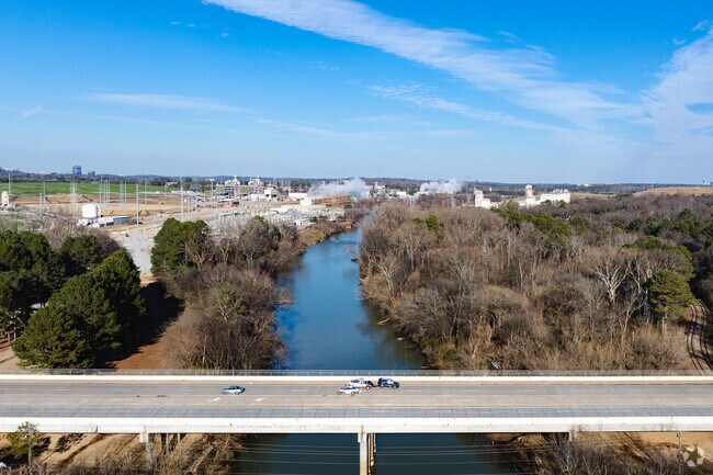 The Chattahoochee River flows peacefully through Whittier Mill Village, adding natural charm