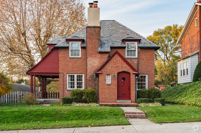 Country living meets nature's beauty in this Tudor Revival residence.