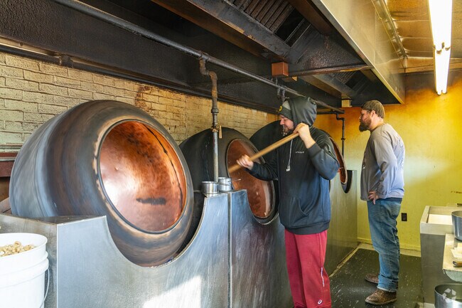 A worker at Naylor Candies prepares some of their famous toffee-covered nuts in Mount Wolf.