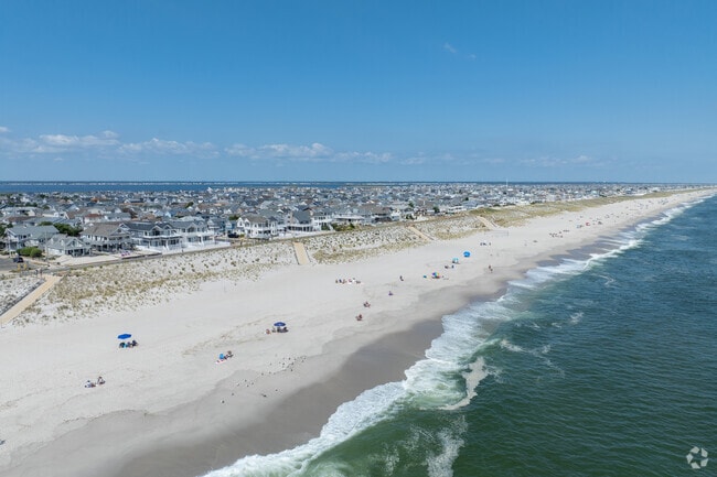 Wide shoreline and rolling surf define Dover Beaches South.
