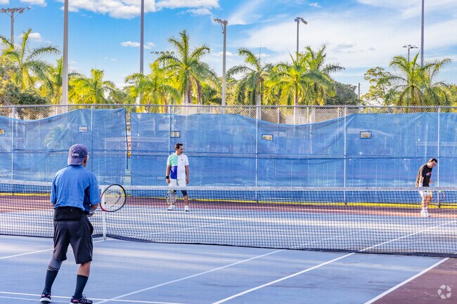 Village Walk residents enjoying a challenging game of tennis in Bob Marcelo park.