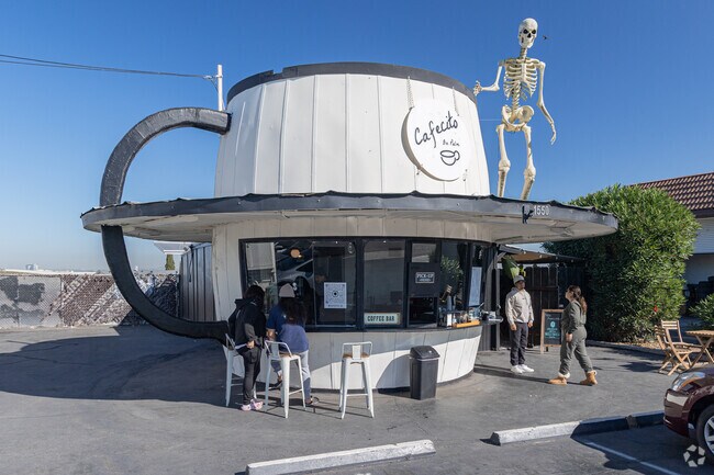 Cafecito on Palm, with its coffee cup shaped building, serves locals on their commutes.