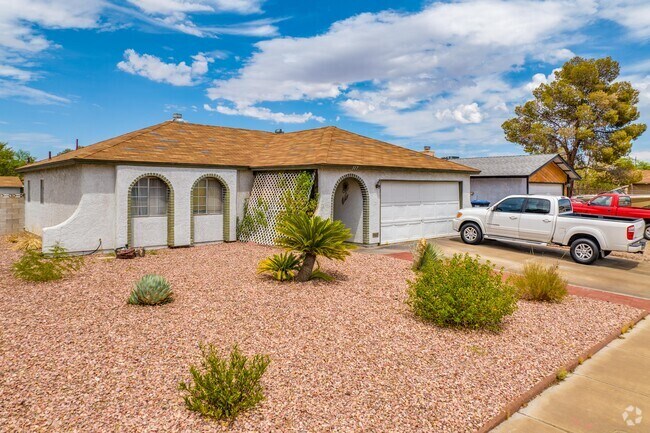 A Spanish-inspired single-family home with desert landscaping in Pittman Nevada.