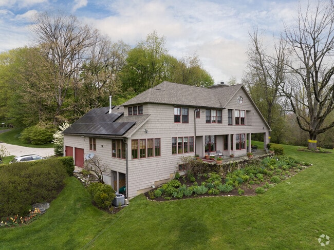 This large contemporary home in Sharon with solar panels for the basics.