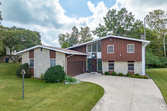 A two-story home in Teakwood features a side-load two-car garage.