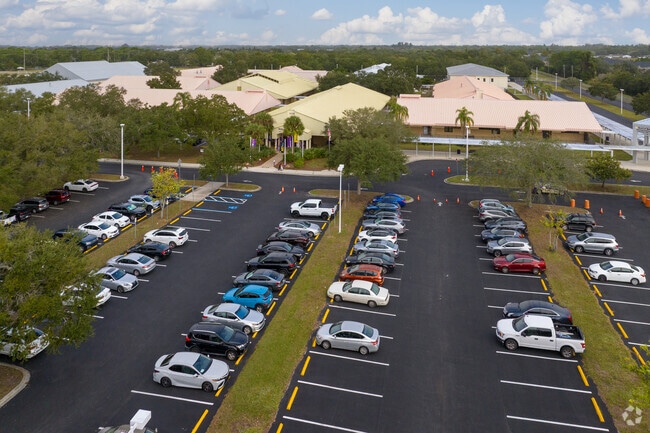 The many buildings of Booker Middle School are painted bright pastel colors.