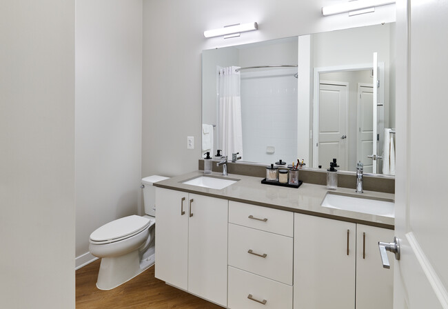 Design Collection II bath with white cabinetry, grey quartz countertops, and hard surface flooring
