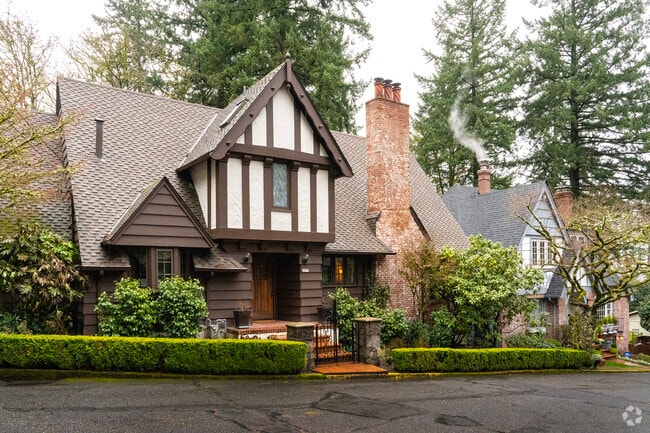 A row of Tudor homes engulfed by evergreens in the Arlington Heights neighborhood.