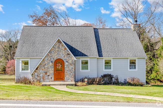 This unique cottage home with a round front door stands proud in the rural Bell Township.