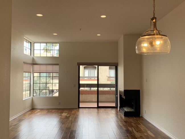 Dining, living room, balcony, fireplace facing north