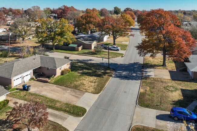 Mature trees pop with color in the fall in Western Village neighborhood.