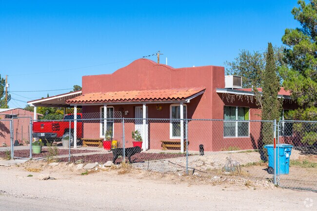 A Spanish Revival home that offers a convenient carport for protection from the elements.