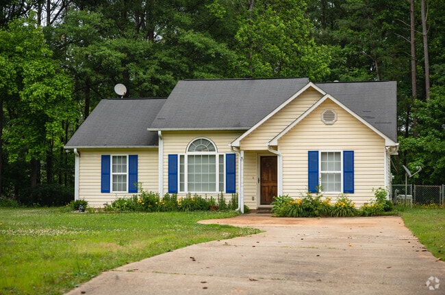 A small bungalow home with a large front yard in Whitney.