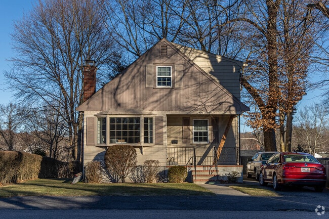 Large trees often surround the homes in Dedham Village.
