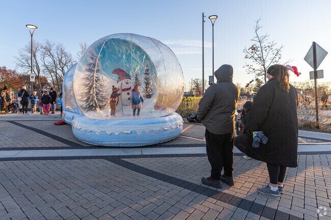 Kids have a blast bouncing in the life sized snow globe at Nile's Holly Jolly Fest.