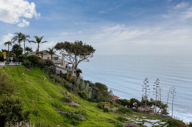 Oceanfront home built into the side of a cliff.
