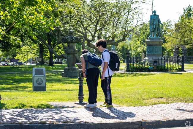 In Historic Hill, RI, young children enjoy refreshing drinks at a local park.