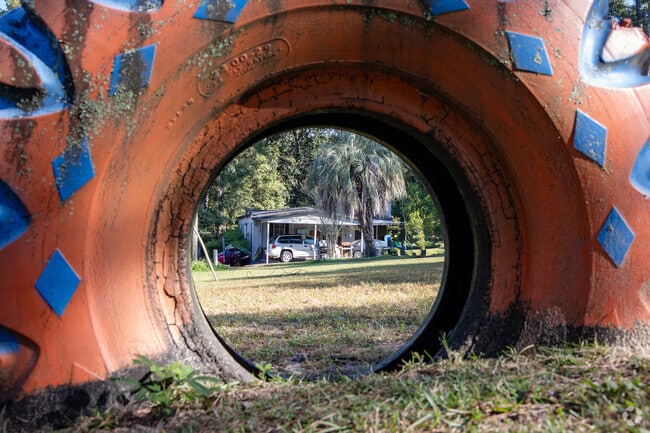 The playground at Deertree Hills has climbing structures, including a decorated tire.