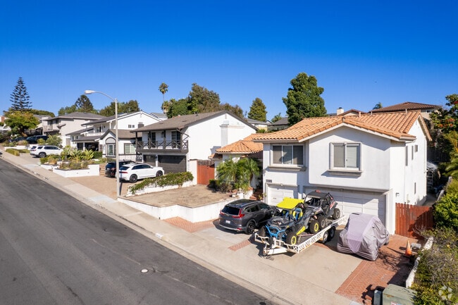 Homes in Dana Hills often include driveways and garages.