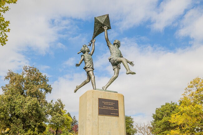 The Moraga Commons Park statue in Rheem, California features two kids flying a kite.
