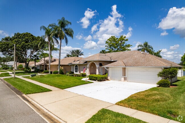 A row of ranch-style homes features attached garages and arched front entrances.