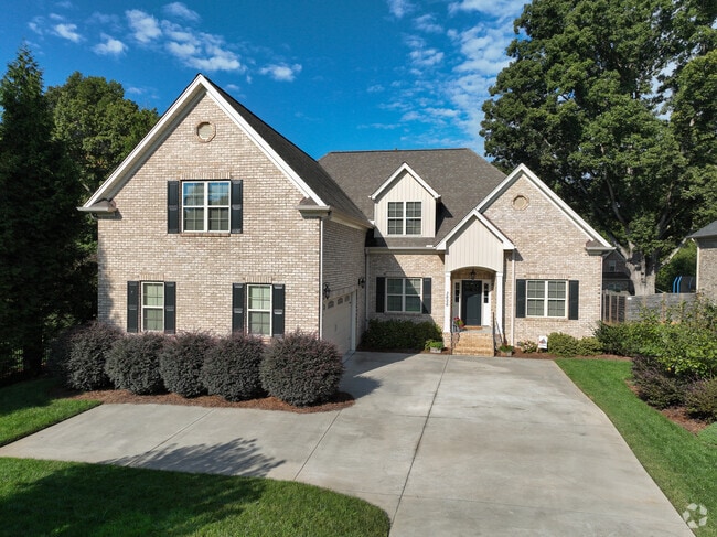A large brick home with a single-car garage in Old Sherwood Forest.