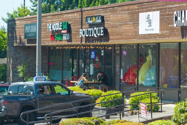 A couple relaxes outside of a retail center on NE Thurston Way in Ogden.