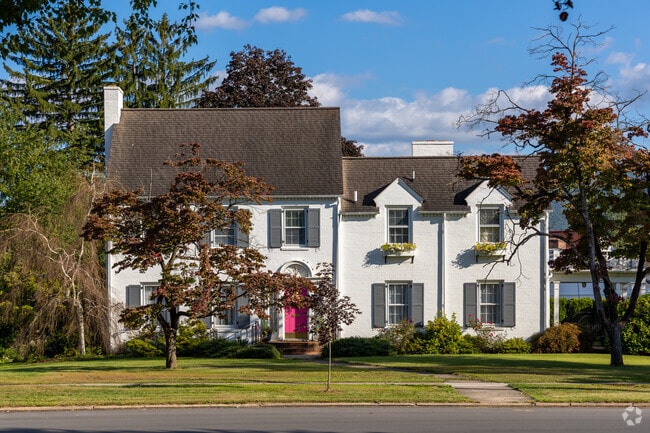 Large Colonial Revival homes surround the pocket park in the center of Faxon.