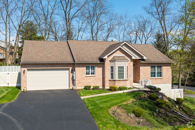 A large brick Ranch home with a fenced yard in Fullerton.