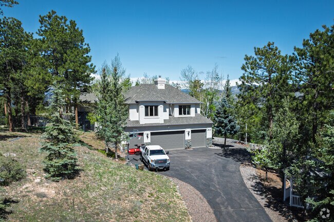 Multi-story mountain homes line the hillsides in North Central Evergreen.