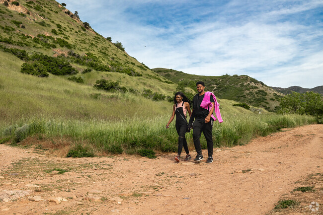 A couple enjoys a sunny day hiking the Living Room Trailhead in University.