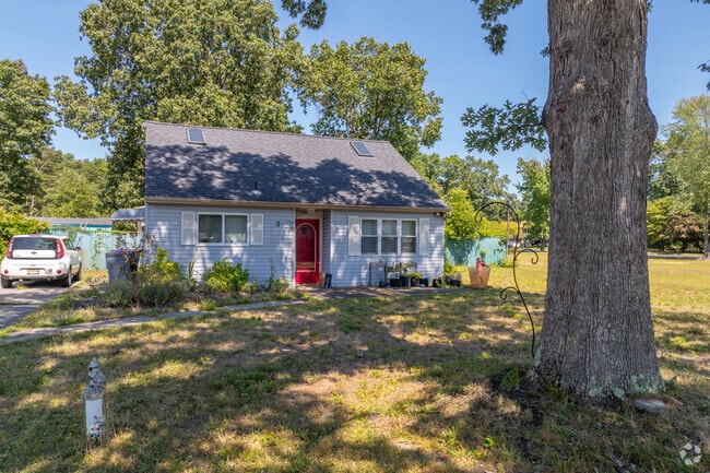 Cape cods in Erial are shaded by the neighborhoods towering pines.