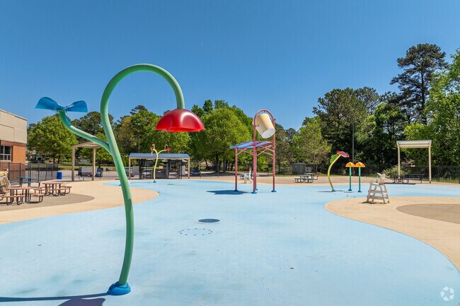 Exchange Park boasts an expansive and vibrant splash pad, complete with colorful water jets that spray in various directions, providing a refreshing oasis for children and families to enjoy during warm summer days.
