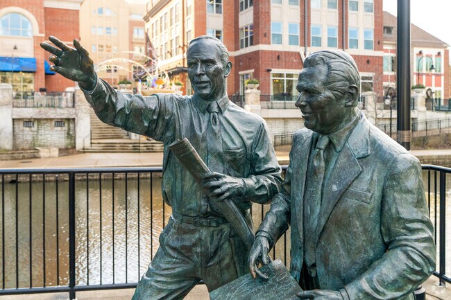 Bronze statues line the The Naperville Riverwalk along the DuPage River.