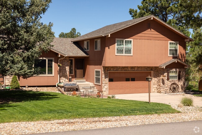 Split level home in The Pinery featuring great stone work and a large front yard.