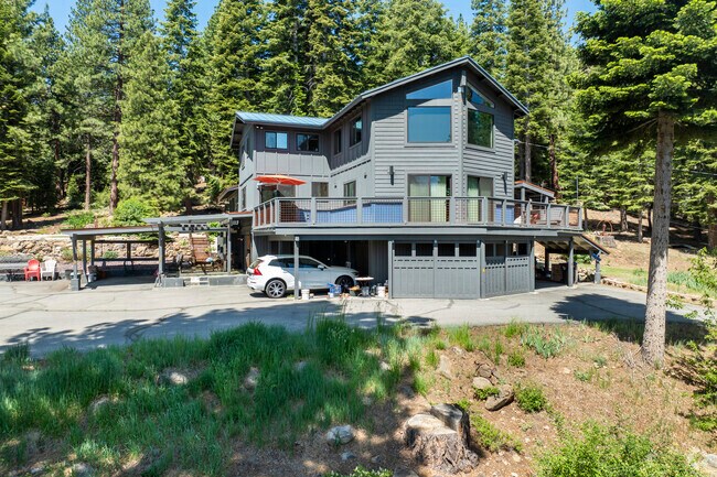 A bold multi-level design with wraparound decks gives this Prosser Lake Heights home striking modern mountain character.