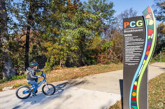 Peachtree Greenway's paved path is popular for biking & strolling steps from Peachtree Corridor.