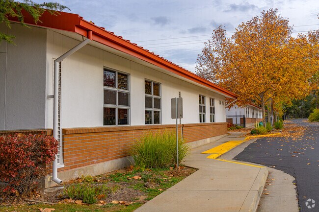 Mature trees full of fall colors line the perimeter of Adelante High (Continuation) School.