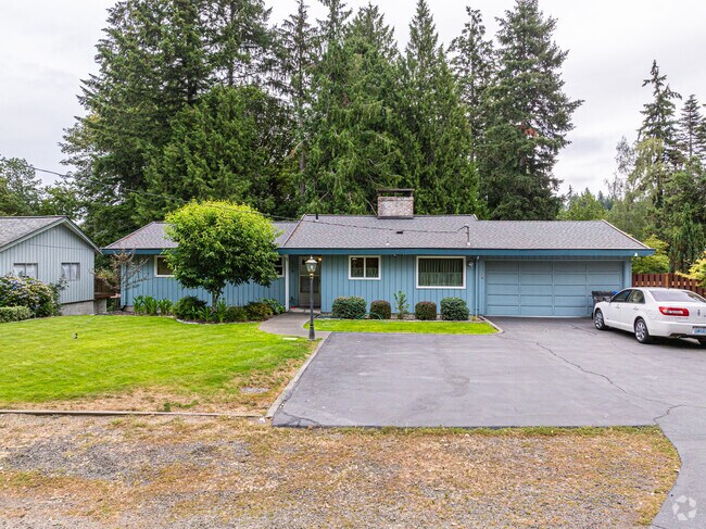 This lovely rancher home has a modest garden and room for a few parked cars.