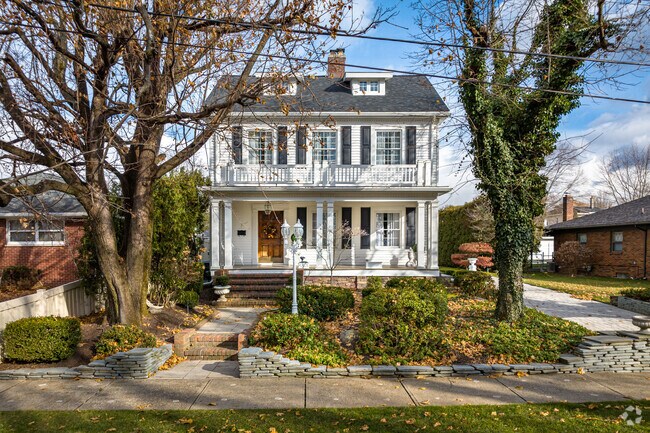 An American Foursquare home with a covered porch standing proudly in Wyoming, PA.