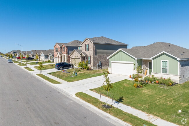 Brick facade one and two-story homes line the quiet streets of Taylor, Texas.