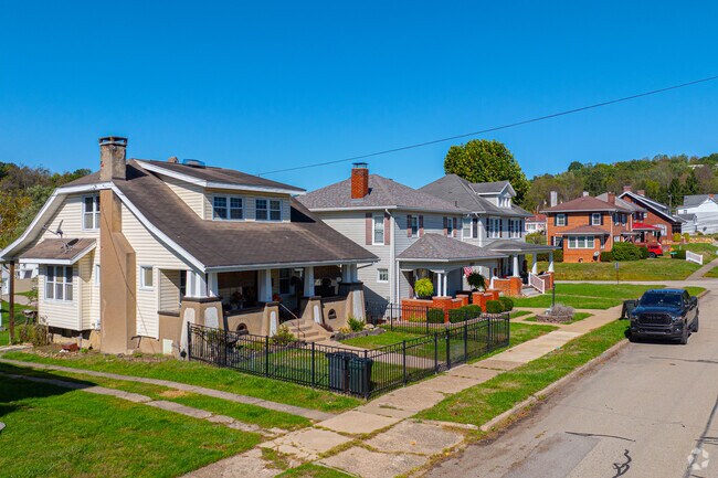 Homes with tidy lawns sit along quiet township streets.