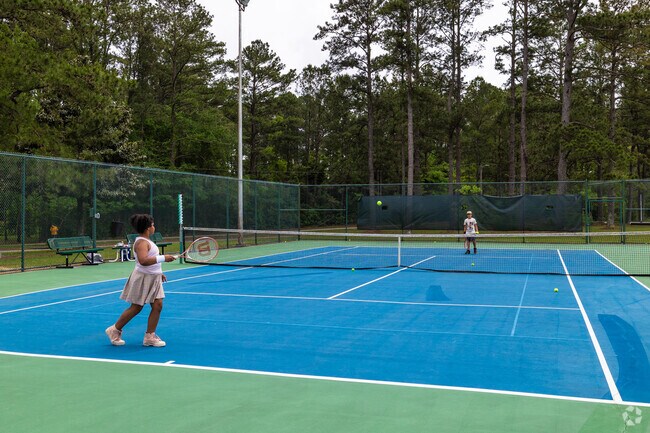 Perfect that back swing at Medal of Honor Park tennis courts near Overton.