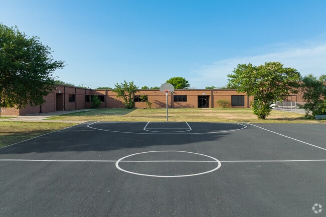 Children can play a game of basketball at the Wells Branch Arts Integration Academy in Austin.