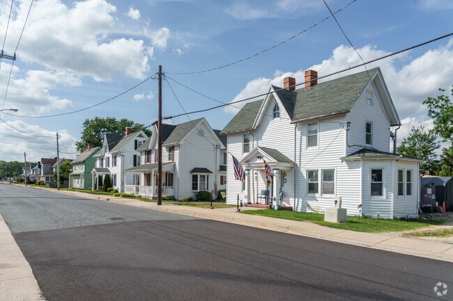 A row of brightly-painted, clapboard Colonial Revival homes line Church Street in Hebron.